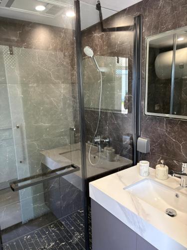 a bathroom with a glass shower and a sink at Capsule house for rent at Gut Holtmann in Billerbeck