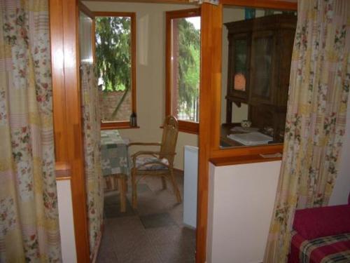 a room with a table and a dining room at Bundi Vendégház in Kehidakustány