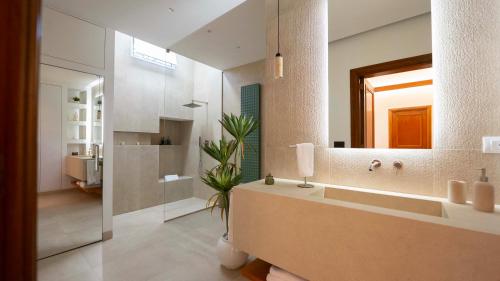 a bathroom with a large sink and a mirror at The Suite - Trani centro in Trani