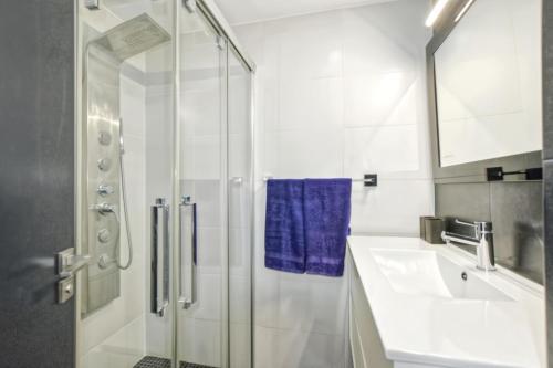 a white bathroom with a shower and a sink at Son Baulo in Can Picafort