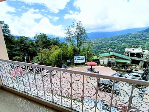 a balcony with a view of a parking lot at CLOUDS Hotel and restaurant in Gangtok
