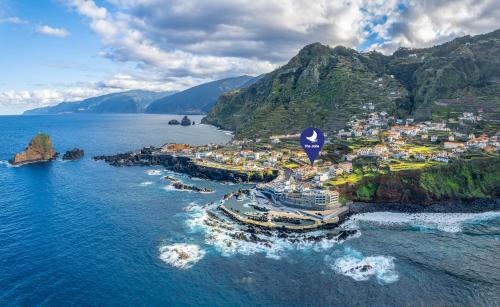 an aerial view of a town on a mountain at The Jolie - Apartments by the Ocean in Porto Moniz