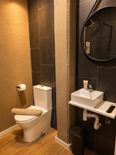 a bathroom with a toilet and a sink and a mirror at Musa in Valencia