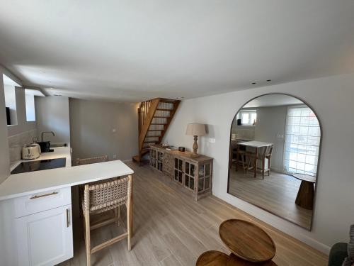 a kitchen and living room with a large mirror at Charmante Maison avec Jardin Privé - PACY SUR EURE in Pacy-sur-Eure