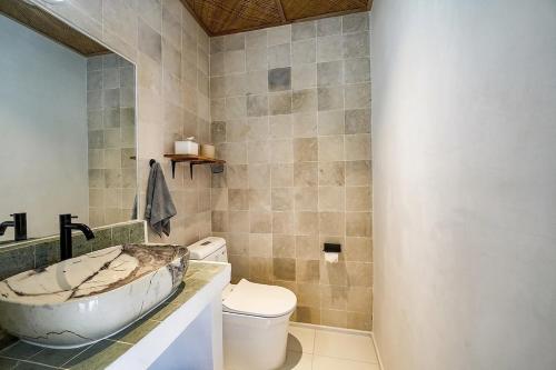 a bathroom with a sink and a toilet at 2BR, Private Pool, Prime Location, Tropikarma in Toyapakeh