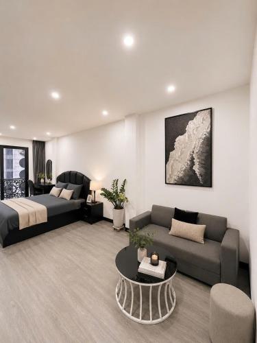 a large living room with a bed and a couch at Sora Westlake - Modern Apartment with Balcony in Hanoi
