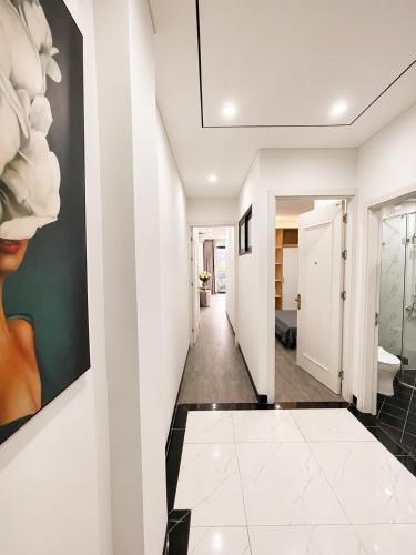 a hallway with white walls and a painting on the wall at Sora Westlake - Modern Apartment with Balcony in Hanoi