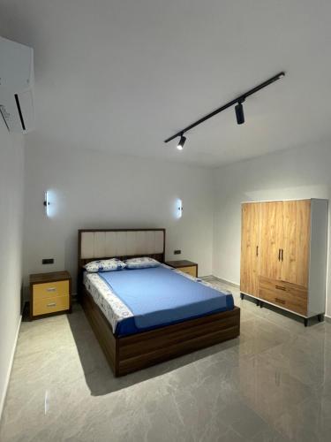 a bedroom with a bed and a wooden cabinet at Oksijen in Urla