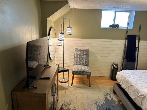 a bedroom with a bed and a desk and a chair at 1 Bedroom Basement Apartment Owen Sound in Owen Sound