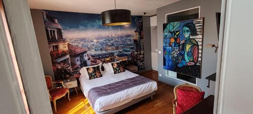 a bedroom with a bed and a painting on the wall at Le Pavillon Hotel in Paris