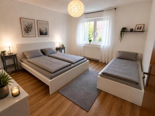 a bedroom with two beds and a window at Pulheim Living 5 in Pulheim