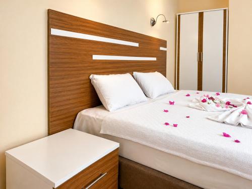 a bedroom with a bed with flowers on it at The Mood Hotel in Gümbet