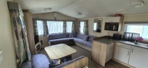 a living room with a couch and a table in an rv at Heatherview Willerby in Bishop Auckland