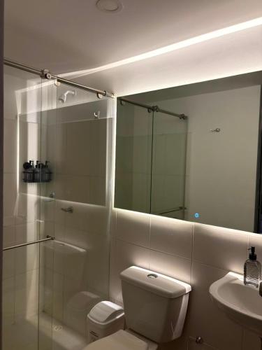 a bathroom with a shower and a toilet and a sink at Monte Bravo Lodge in Yopal
