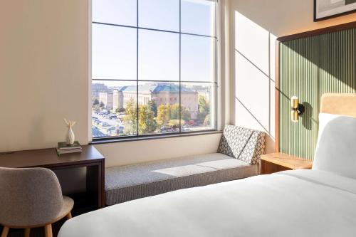 a hotel room with a bed and a window at Arlo Washington DC in Washington, D.C.