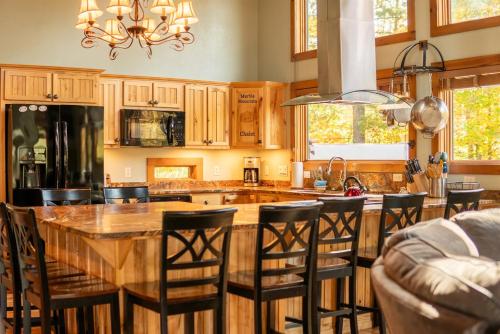 a kitchen with a large wooden table and chairs at Beautiful Home, Views, Near Whiteface, Lake Placid in Wilmington