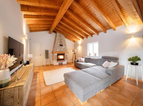 a large living room with a couch and a fireplace at Seashore Escape by Lisbeyond in Aljezur