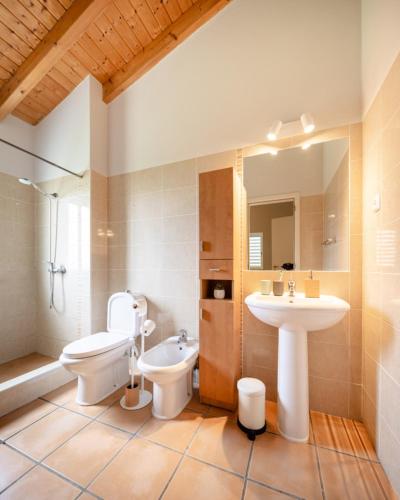 a bathroom with a sink and a toilet and a sink at Seashore Escape by Lisbeyond in Aljezur