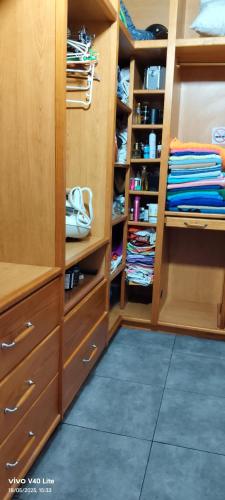 a walk in closet with wooden cabinets and a blue floor at Lindas Vistas in Tías