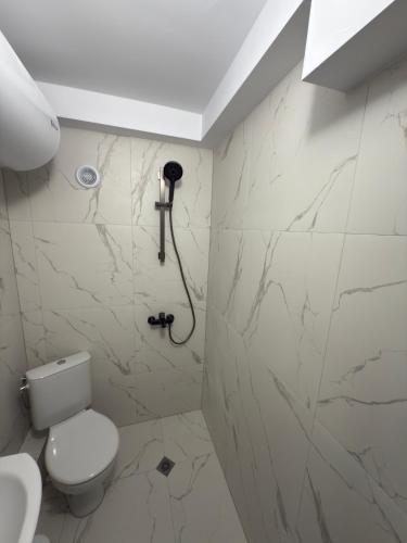 a bathroom with a toilet and a shower at Storm in Varna City