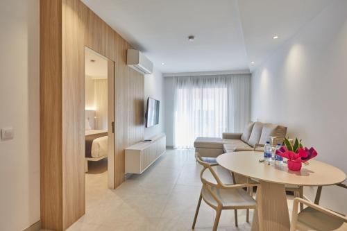 a living room with a table and a couch at Silken Atlantis Playa - Holiday Homes in Las Palmas de Gran Canaria