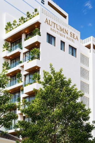 an apartment building with a sign that reads autumn sea boutique hotel at Autumn Sea Boutique Hotel in Nha Trang