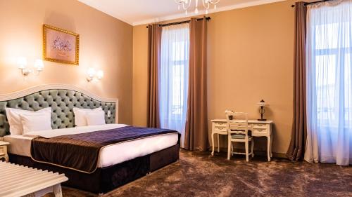 a hotel room with a bed and a desk at Grand Hotel Traian in Iaşi