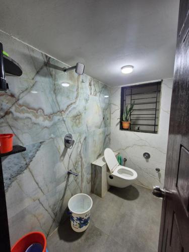 a bathroom with a toilet and a sink at Todkars Villa in Kolhapur