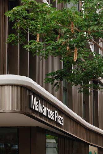 a building with a sign that reads malaya plaza at Intelier Malvarrosa Plaza in Valencia