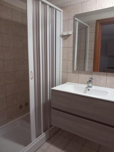 a bathroom with a sink and a mirror and a shower at Green Park Residence in Foce Varano