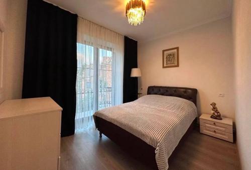 a bedroom with a bed and a large window at City Center in Vanadzor