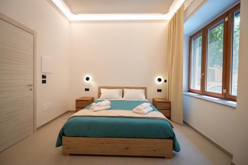 a bedroom with a bed with two towels on it at B&B Hipponion in Vibo Valentia
