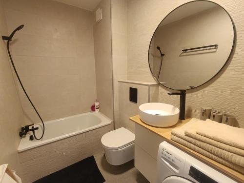 a bathroom with a sink toilet and a mirror at Blanco&Azul - Ocean View Balcony, Pool and Perfect Location in Playa de las Americas