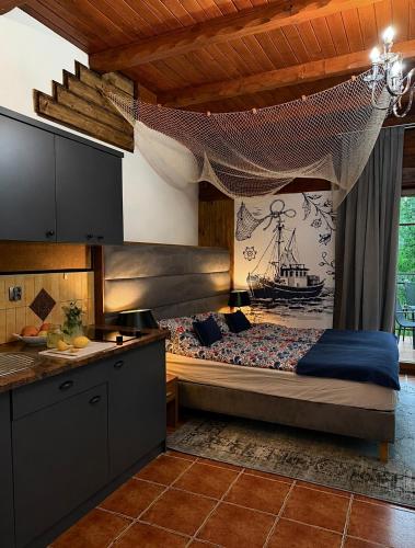 a kitchen with a bed in a room at Detlafówka Kaszubski Resort in Dębki