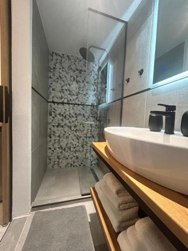 a bathroom with a sink and a shower at The Square Point in Komotini