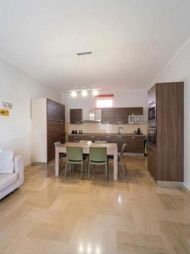 a kitchen and living room with a table and chairs at Appartamento Mina' in Adrano