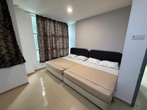a bedroom with a large bed in front of a window at Hotel Empire Banting in Banting