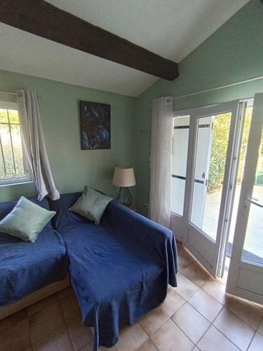 a bedroom with two beds and a sliding glass door at La maison multicolore in Salon-de-Provence