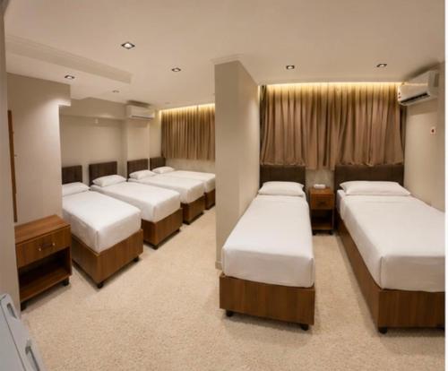 a room with a row of beds in it at فندق وفادة الزهراء in Baghdād