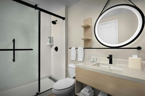 a bathroom with a sink and a mirror at TownePlace Suites Des Moines Urbandale in Johnston