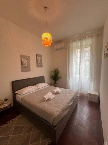 a bedroom with a bed with two towels on it at Residence Emporium in Rome