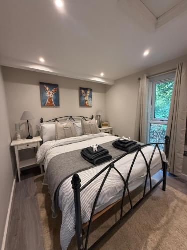 a bedroom with a large bed with towels on it at The Willow Luxury Countryside Retreat in Stone
