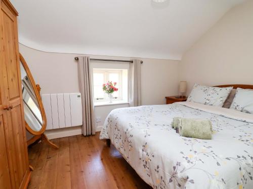 a bedroom with a bed and a window at Pen Y Grisiau in Mold