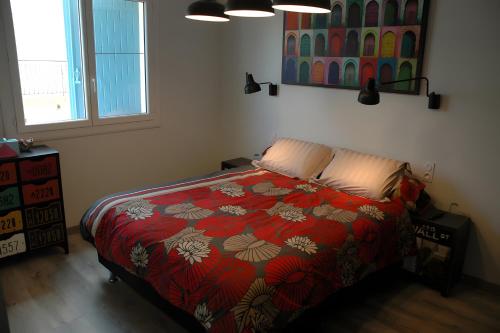 a bedroom with a bed with a colorful comforter at Cabesthotes in Cabestany