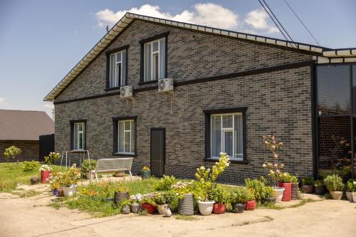 a house with a bunch of plants in front of it at FlowerHouse in Karakol