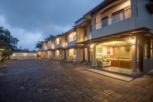 a cobblestone street in front of a building at Treebo Five Elements with Swimming Pool in Lonavala