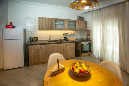 a kitchen with a table with a bowl of fruit on it at Anastasios' artwork apartment in Thessaloniki