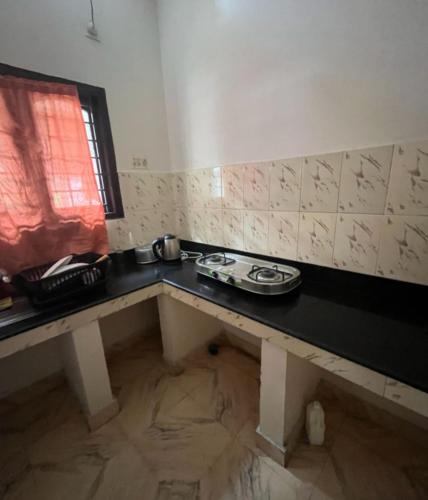 a room with a table with a sink and a window at Taj Mahal Hotel in Cochin