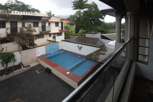 a view of a swimming pool on a balcony at Treebo Five Elements with Swimming Pool in Lonavala