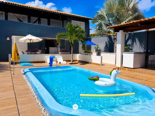 a swimming pool with a pool toy in a house at Pousada On the Beach - Aquiraz/CE in Aquiraz